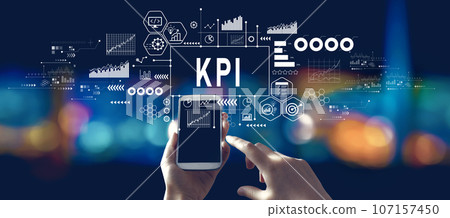 KPI - Key Performance Indicator theme with person using a smartphone at night KPI - Key Performance Indicator theme with person using a smartphone at night 107157450