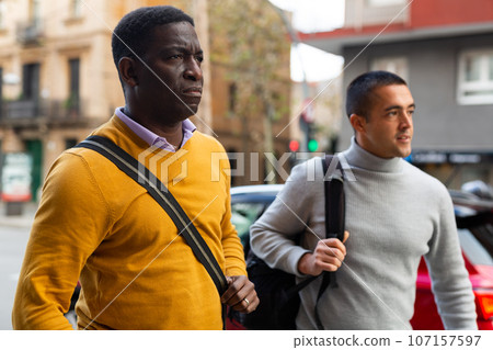 Two men going through town streets 107157597