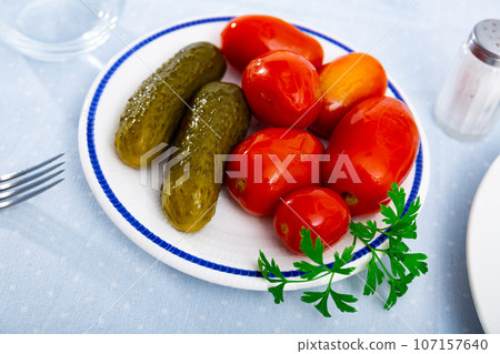 Appetizing pickled cucumbers and tomatoes Appetizing pickled cucumbers and tomatoes 107157640