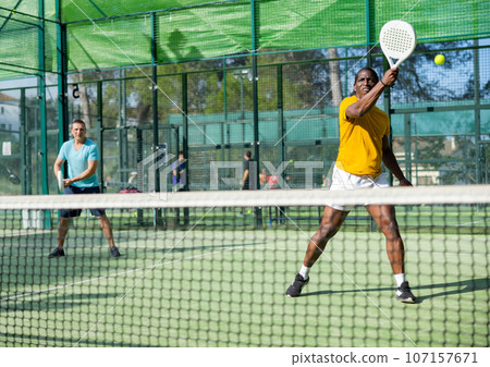 African american man padel tennis player trains on the court African american man padel tennis player trains on the court 107157671