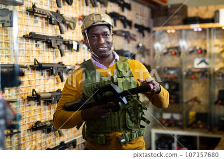 African-american man in weapon shop African-american man in weapon shop 107157680
