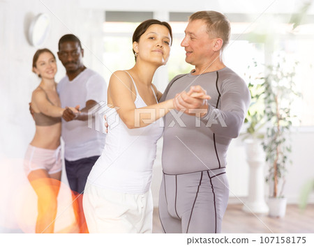 Adult man and young woman dancing pair dance 107158175