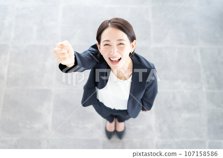 A woman in a suit that makes a guts pose A woman in a suit that makes a guts pose 107158586