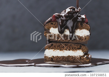 Photo material of sweets pouring chocolate syrup on cake 107158851