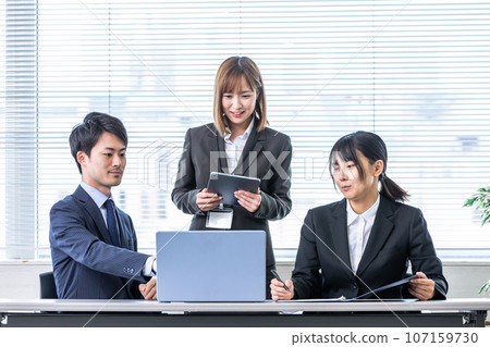 A man and a woman having fun chatting in the office 107159730