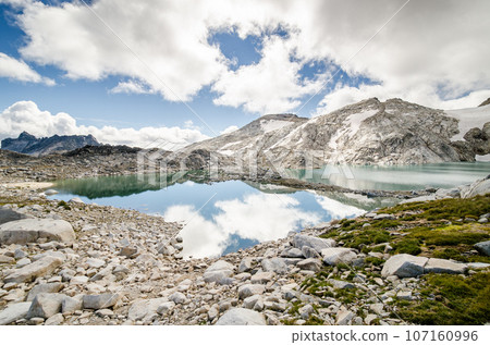 Fluffy clouds reflecting in Isolation Lake Fluffy clouds reflecting in Isolation Lake 107160996