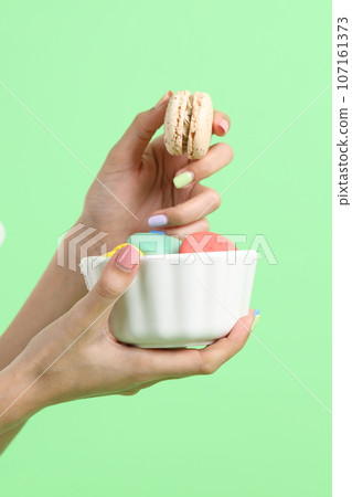 Hand with Macaroons Hand with Macaroons 107161373