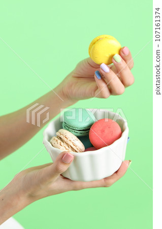Hand with Macaroons Hand with Macaroons 107161374