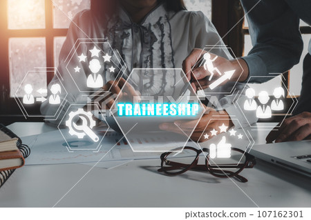 Traineership conept, Business team working on digital tablet in office with traineership icon on virtual screen. Traineership conept, Business team working on digital tablet in office with traineership icon on virtual screen. 107162301