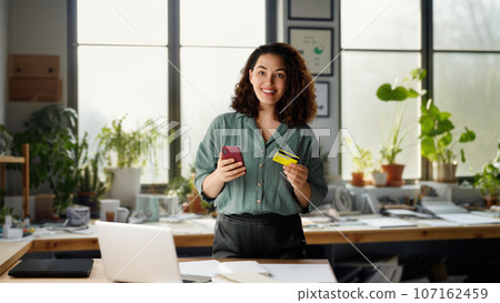 Woman is doing online purchases Woman is doing online purchases 107162459