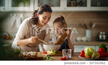 Happy family in the kitchen. Happy family in the kitchen. 107162462