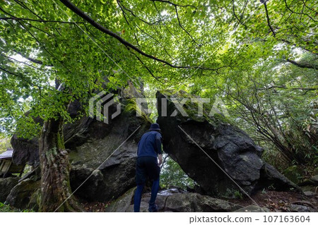 A man tries to go through a dark tunnel because he wants to see what lies ahead. A man tries to go through a dark tunnel because he wants to see what lies ahead. 107163604