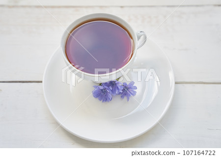 Delicious chicory drink, cups and saucers on a wooden table with a place to copy. A healthy drink made from chicory. High quality photo Delicious chicory drink, cups and saucers on a wooden table with a place to copy. A healthy drink made from chicory. High quality photo 107164722