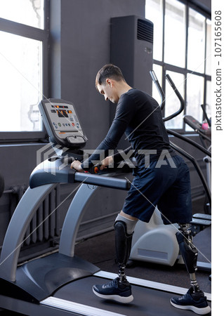ambitious man concentrated on walking on treadmill ambitious man concentrated on walking on treadmill 107165608