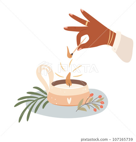 Womans hand light a candle. Cozy autumn days  107165739
