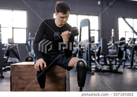 motivated man with a disability with a prosthetic leg is training motivated man with a disability with a prosthetic leg is training 107165802