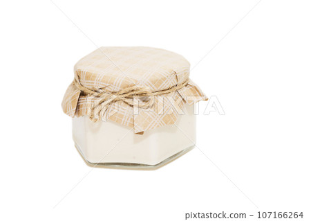 Three glass jars with jam on a white background Three glass jars with jam on a white background 107166264