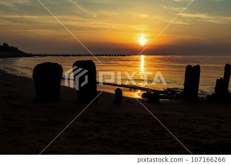 Sunset over the water on a dark background of sunlight over the Mediterranean Sea Sunset over the water on a dark background of sunlight over the Mediterranean Sea 107166266
