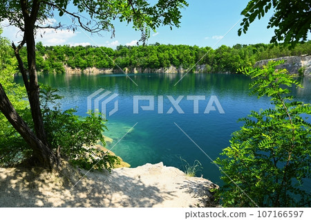 Beautiful flooded quarry with clear water for swimming. Summer landscape concept with nature. Masovice - Czech Republic. 107166597