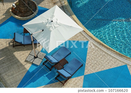 Parasol placed by the pool Parasol placed by the pool 107166620