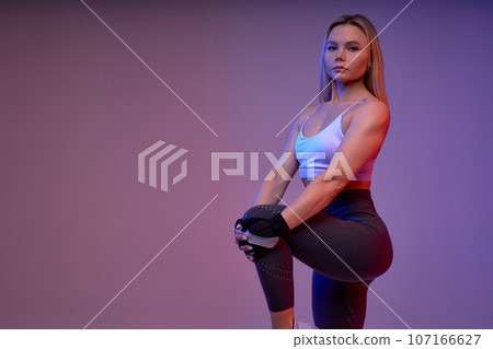 serious strong sportswoman lifting legs serious strong sportswoman lifting legs 107166627