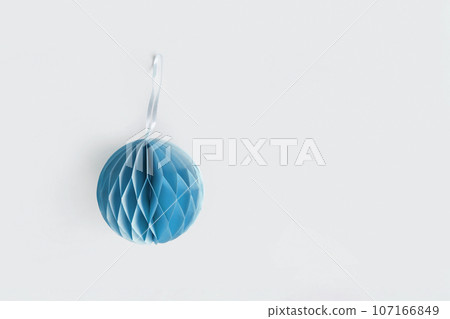 Paper Christmas honeycomb ornaments. Handmade blue foldable decor. Concept of winter creativity crafts. Trendy eco DIY. Scandinavian Modern decoration. Top view Boho Style Structural 3d Origami Toy Paper Christmas honeycomb ornaments. Handmade blue foldable decor. Concept of winter creativity crafts. Trendy eco DIY. Scandinavian Modern decoration. Top view Boho Style Structural 3d Origami Toy 107166849