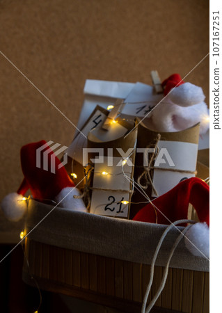 Original Advent Calendar for Christmas Homemade. Preparation to Christmas concept. Family winter holidays. Eco friendly presents gifts. open the package every day Original Advent Calendar for Christmas Homemade. Preparation to Christmas concept. Family winter holidays. Eco friendly presents gifts. open the package every day 107167251