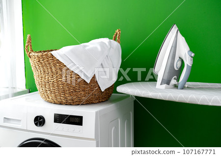 Laundry basket on washing machine in a laundry room 107167771