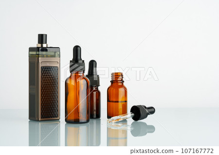 Electronic cigarette with smoking liquid bottle on white background 107167772