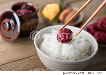 Traditional sour pickled plums (Kishu Nankoume) served with warm rice. Traditional sour pickled plums (Kishu Nankoume) served with warm rice. 107168275