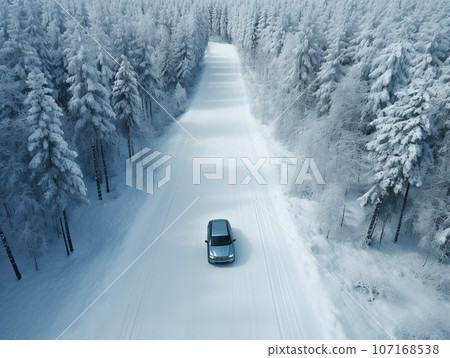 Car driving on snow covered forest road in winter. Car driving on snow covered forest road in winter. 107168538