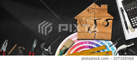 Wooden Model House Made of Puzzle Pieces and Work Tools 107168568