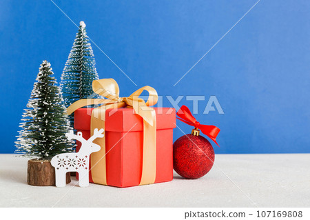 Christmas composition. craft Gift box, small tree, branches and craft DIY decorations on white background. New year concept. Christmas home decoration Flat lay, top view, copy space 107169808