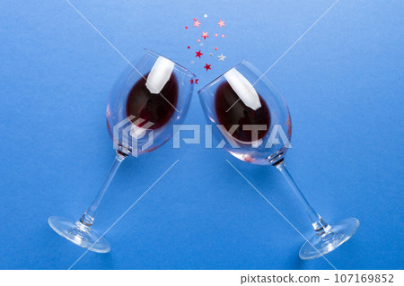 Many glasses of red wine at wine tasting. Concept of red wine on colored background. Top view, flat lay design Many glasses of red wine at wine tasting. Concept of red wine on colored background. Top view, flat lay design 107169852