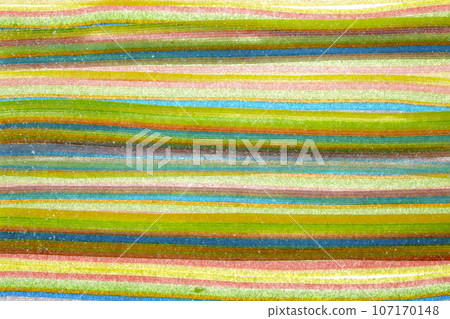 Marmalade is lined with bright multicolored stripes in rows sprinkled with sugar. Marmalade is lined with bright multicolored stripes in rows sprinkled with sugar. 107170148