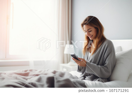 Woman on Bed with Her Cellphone Woman on Bed with Her Cellphone 107171291