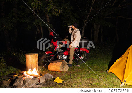Camping of a biker man who seems to be riding a motorcycle and driving drunk 107172796