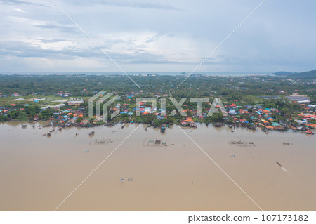 Aerial view of fishing trap net in canel with fisherman urban city village town houses, lake or river. Nature landscape fisheries and fishing tools at Pak Pha, Songkhla, Thailand. Aquaculture farming Aerial view of fishing trap net in canel with fisherman urban city village town houses, lake or river. Nature landscape fisheries and fishing tools at Pak Pha, Songkhla, Thailand. Aquaculture farming 107173182