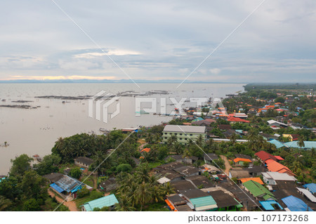 Aerial view of fishing trap net in canel with fisherman urban city village town houses, lake or river. Nature landscape fisheries and fishing tools at Pak Pha, Songkhla, Thailand. Aquaculture farming Aerial view of fishing trap net in canel with fisherman urban city village town houses, lake or river. Nature landscape fisheries and fishing tools at Pak Pha, Songkhla, Thailand. Aquaculture farming 107173268