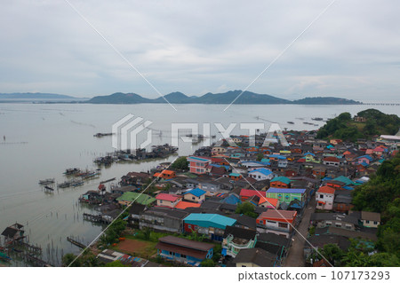 Aerial view of fishing trap net in canel with fisherman urban city village town houses, lake or river. Nature landscape fisheries and fishing tools at Pak Pha, Songkhla, Thailand. Aquaculture farming 107173293