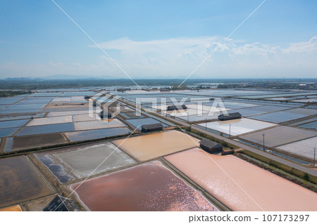 Aerial view of natural sea salt ponds, lake or sea. Farm field outdoor in traditional industry in Thailand. Asia culture. Agriculture irrigation. River reflection. 107173297