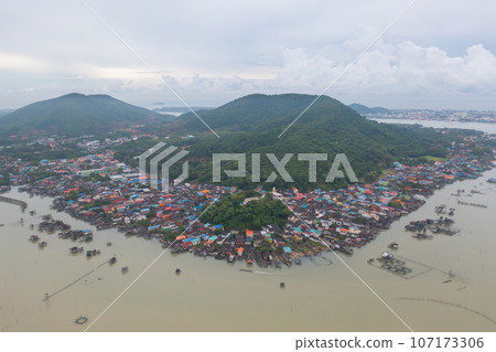 Aerial view of fishing trap net in canel with fisherman urban city village town houses, lake or river. Nature landscape fisheries and fishing tools at Pak Pha, Songkhla, Thailand. Aquaculture farming 107173306