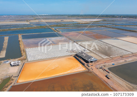 Aerial view of natural sea salt ponds, lake or sea. Farm field outdoor in traditional industry in Thailand. Asia culture. Agriculture irrigation. River reflection. 107173309