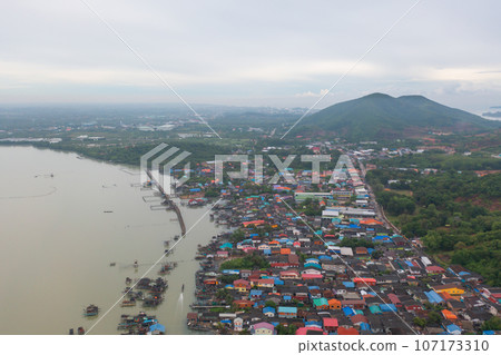 Aerial view of fishing trap net in canel with fisherman urban city village town houses, lake or river. Nature landscape fisheries and fishing tools at Pak Pha, Songkhla, Thailand. Aquaculture farming Aerial view of fishing trap net in canel with fisherman urban city village town houses, lake or river. Nature landscape fisheries and fishing tools at Pak Pha, Songkhla, Thailand. Aquaculture farming 107173310