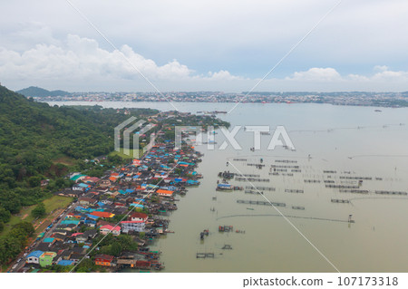 Aerial view of fishing trap net in canel with fisherman urban city village town houses, lake or river. Nature landscape fisheries and fishing tools at Pak Pha, Songkhla, Thailand. Aquaculture farming Aerial view of fishing trap net in canel with fisherman urban city village town houses, lake or river. Nature landscape fisheries and fishing tools at Pak Pha, Songkhla, Thailand. Aquaculture farming 107173318