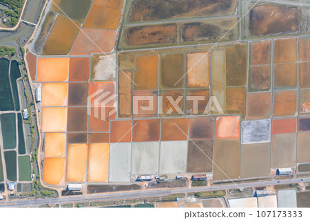 Aerial view of natural sea salt ponds, lake or sea. Farm field outdoor in traditional industry in Thailand. Asia culture. Agriculture irrigation. River reflection. Aerial view of natural sea salt ponds, lake or sea. Farm field outdoor in traditional industry in Thailand. Asia culture. Agriculture irrigation. River reflection. 107173333