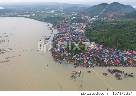 Aerial view of fishing trap net in canel with fisherman urban city village town houses, lake or river. Nature landscape fisheries and fishing tools at Pak Pha, Songkhla, Thailand. Aquaculture farming Aerial view of fishing trap net in canel with fisherman urban city village town houses, lake or river. Nature landscape fisheries and fishing tools at Pak Pha, Songkhla, Thailand. Aquaculture farming 107173334