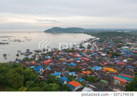 Aerial view of fishing trap net in canel with fisherman urban city village town houses, lake or river. Nature landscape fisheries and fishing tools at Pak Pha, Songkhla, Thailand. Aquaculture farming Aerial view of fishing trap net in canel with fisherman urban city village town houses, lake or river. Nature landscape fisheries and fishing tools at Pak Pha, Songkhla, Thailand. Aquaculture farming 107174016