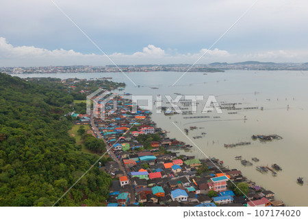 Aerial view of fishing trap net in canel with fisherman urban city village town houses, lake or river. Nature landscape fisheries and fishing tools at Pak Pha, Songkhla, Thailand. Aquaculture farming Aerial view of fishing trap net in canel with fisherman urban city village town houses, lake or river. Nature landscape fisheries and fishing tools at Pak Pha, Songkhla, Thailand. Aquaculture farming 107174020