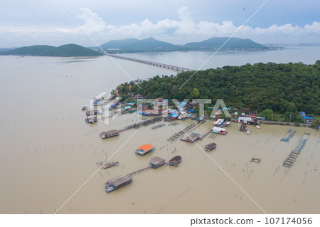 Aerial view of fishing trap net in canel with fisherman urban city village town houses, lake or river. Nature landscape fisheries and fishing tools at Pak Pha, Songkhla, Thailand. Aquaculture farming Aerial view of fishing trap net in canel with fisherman urban city village town houses, lake or river. Nature landscape fisheries and fishing tools at Pak Pha, Songkhla, Thailand. Aquaculture farming 107174056